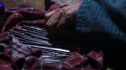 Macro view artisan hand reaching for iron carving chisel tool on workshop t.. Stock Footage 344645524