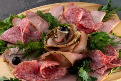 Macro view assorted sliced delicious meat mix as salami, bacon and ham with p 库存照片