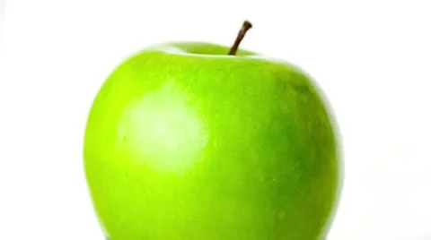 Macro view of beautiful bright green apple sitting still as water flows over  Stock Footage 62759792