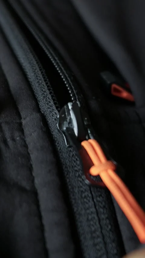 Macro View of Black Zipper Slider Closing on Technical Fabric Vídeos de archivo 338096562