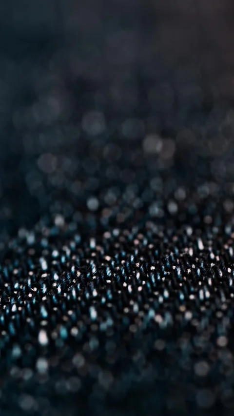 Macro view of blue denim fabric texture showing intricate weave and fiber d.. Stock Footage 339409212