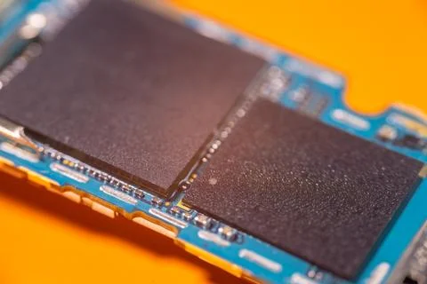 Macro view of blue electronic circuit board with two black rectangular comp.. Stock-Fotos