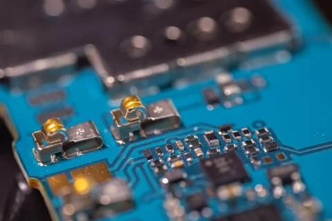 Macro view of blue electronic circuit board with microchips, metallic conne.. Stock Photos