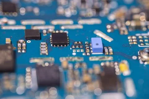 Macro view of blue electronic circuit board with integrated chips, capacito.. Stock Photos