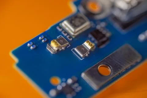 Macro view of blue electronic circuit board with microchips, metal contacts.. Stock Photos