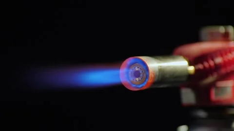Macro view of blue flame burning from industrial gas torch nozzle on black .. Stock Footage 334828804