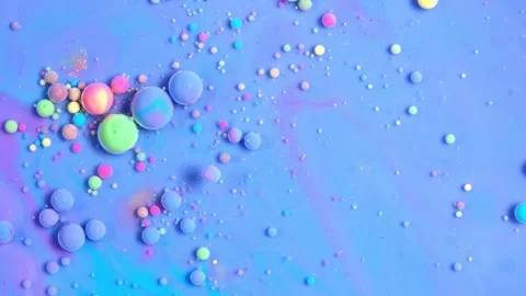 Macro View Blue Green Pink and Yellow Paint Bubbles in Liquid 4K Video stock 332134700