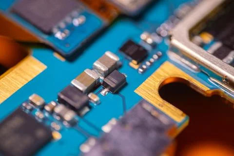 Macro view of blue printed circuit board with metallic electronic component.. Stock Photos