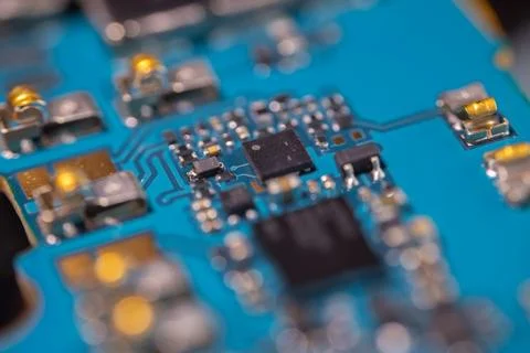 Macro view of blue printed circuit board with black integrated circuits, me.. Stock Photos