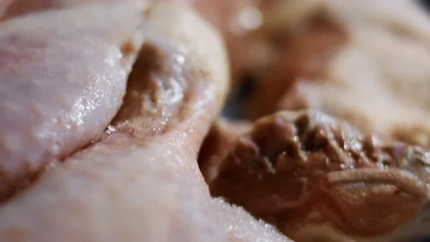 Macro view of a box full of frozen chicken legs. Frozen raw chicken meat covered Stock Footage 145696834