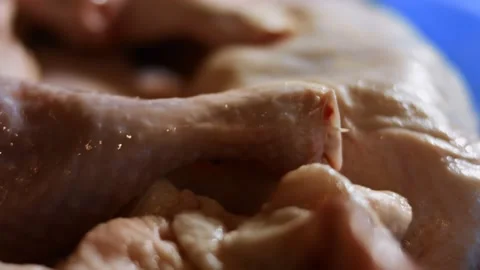 Macro view of a box full of frozen chicken legs. Frozen raw chicken meat covered Stock Footage 145697515