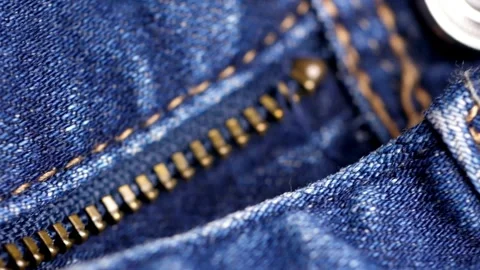 Macro view of brass zipper and button on denim Stock Footage 332284431