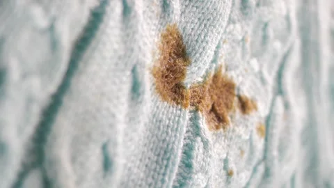 Macro view of brown chocolate stain on blue knitted sweater fabric with det.. Stock Footage 332028877