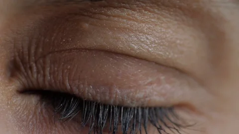 Macro view of brown eye that blink. Retina close-up 動画素材 105069666