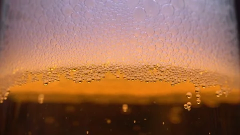 Macro view of bubbles on the walls of a glass. Foam in a glass, beer or champ Stock Footage 169995084