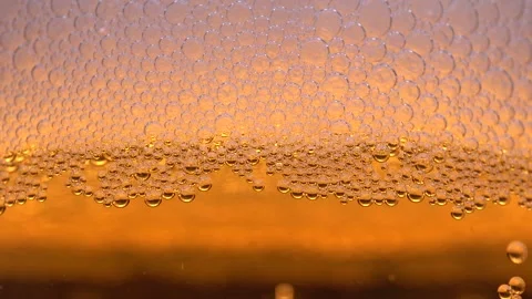 Macro view of bubbles on the walls of a glass. Foam in a glass, beer or champ Stock-Footage 203821422