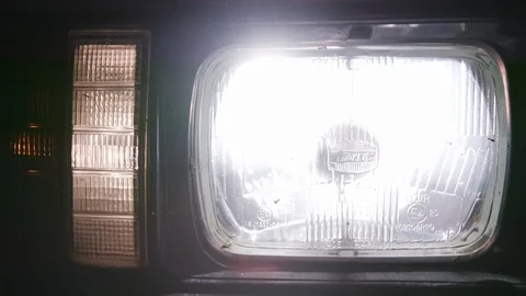 Macro view of the car lamp headlight flashing at night. Front of the modern car Vídeo Stock 105929774