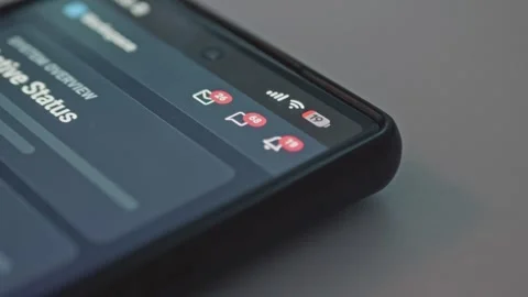 Macro view of cell phone displaying red notification icons with rapidly rising 库存影片 341569595