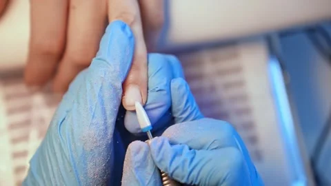 Macro view of a ceramic nail drill bit positioned for professional manicure Stock Footage 333654526