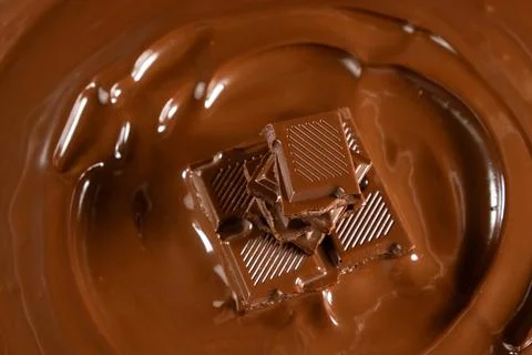 Macro view of chocolate bar pieces in melted chocolate pool 写真素材