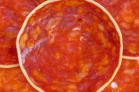 Macro view chorizo slice surface detail revealing intense red and orange hues Stock Photos
