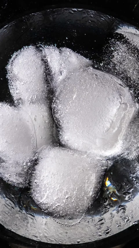 Macro View of Cold Ice Cubes Melting and Shifting Against Dark Background Stock Footage 339366218