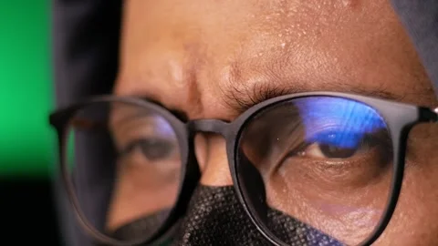 Macro view of computer hacker's eye with glasses looks at monitors Stock Footage 280177429