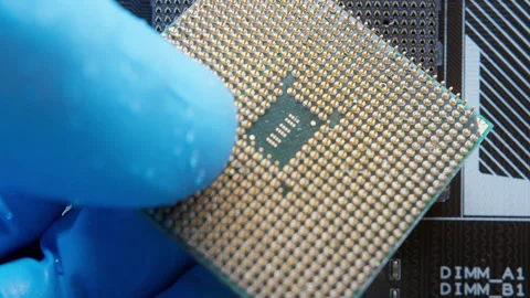 Macro view of a computer processor (CPU) being carefully held with gloves, .. Stock Footage 311335285