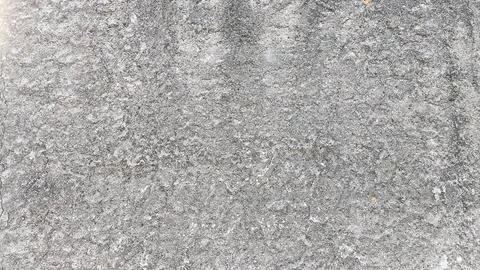 Macro view of concrete wall texture showcasing mild cracks, stains, and une.. Stock Photos