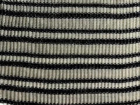Macro view of cozy ribbed knit fabric texture with black and cream horizontal Stock Photos