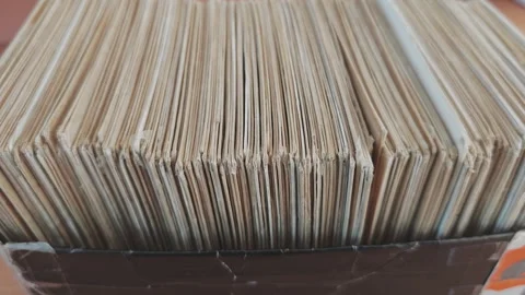 Macro view of a crate full of antique LPs. Numerous vinyl records with aged Stock Footage 346771266