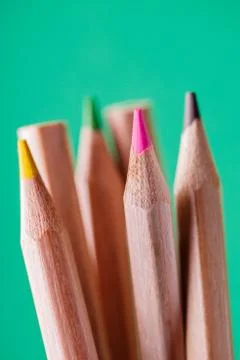 Macro view of crayons. Colored Pencils. Colored pencils on green background. Stock Photos