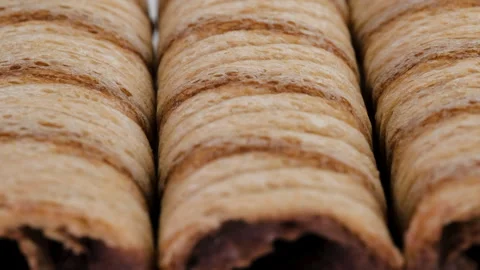 Macro view of cream filled striped wafer rolls. Slider shot. Stock Footage 296925358