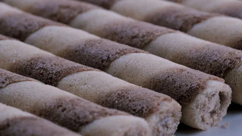 Macro view of cream filled wafer rolls stack together. Slider shot. Stock Footage 296925937