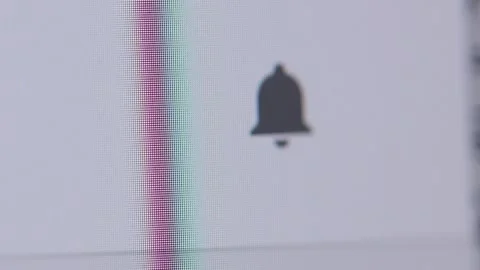 Macro view of a cursor clicking a grey notification bell icon, which highlights  Stock Footage 342777973