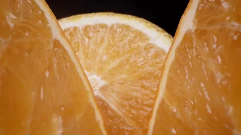 Macro view of cut orange in black background, delicious juicy citrus fruit 스톡 동영상 236534812