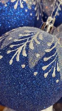 Macro view of a deep blue glitter Christmas bauble with a detailed white sn.. Stock Photos