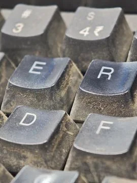 Macro view of dirty computer keyboard keys covered in thick dust and lint n.. Stock Photos