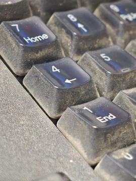 Macro view of dirty computer keyboard keys covered in thick dust and lint n.. Stock Photos