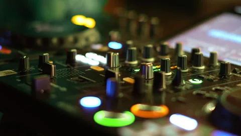 Macro view of dj mixer knobs and illuminated cue button Stock Footage 337790095