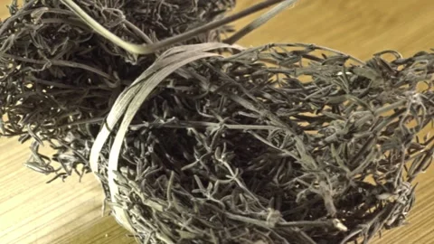 Macro View of Dried Herb Bundles with Twisted Stems on Wooden Surface in Mexico Vídeos de archivo 345101239