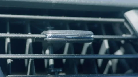 Macro view of dusty car dashboard air vent slatted grill Видео 338028049