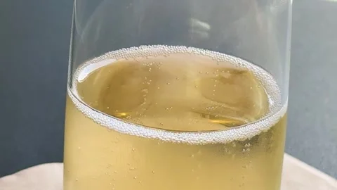 Macro View of Effervescent Champagne Bubbles Rising in a Glass Stockbeeldmateriaal 328281098