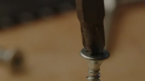 Macro view of electric screw driver drill bit drilling screw in slow motion Stock Footage 261129159