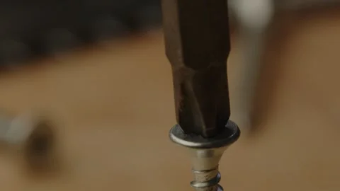 Macro view of electric screwdriver drilling out metal screw in slow motion Stock Footage 261129137