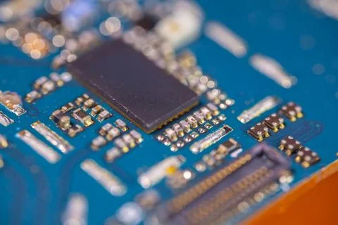 Macro view of electronic circuit board with black microchip, metallic compo.. Stock Photos