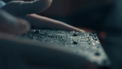 Macro view of engineer's hands holding and closely analizing a GPU Graphic card Stock Footage 145775583
