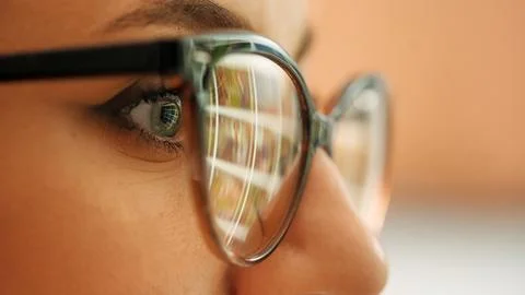 Macro view into the eye of a computer hacker as he monitors a computer screen Stock Photos