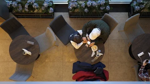 Macro view. Father and son in a cafe watching videos on the phone, playing Stockbeeldmateriaal 126904979