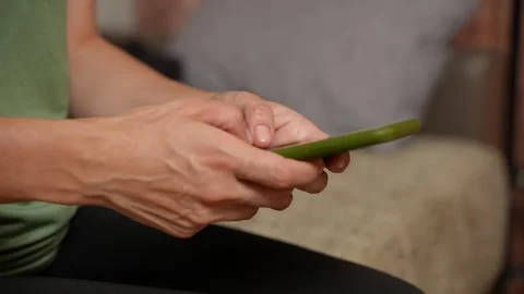 Macro view of female hands actively composing text on a mobile phone. Rapid Video stock 317459087